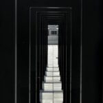 Explore the symmetry of a modern urban passageway with strong geometric lines and minimalist design.
